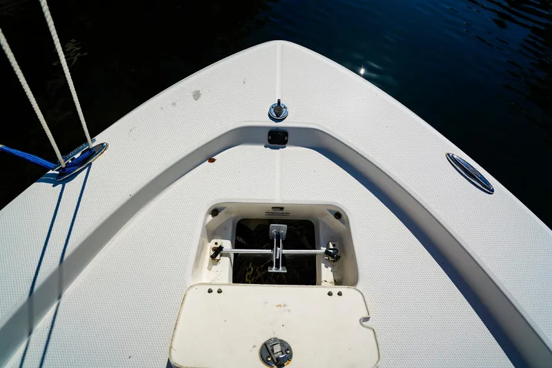 Slide: The Image of Bow of 2016 Robalo 206 Cayman boat with anchor storage, on calm water. - 4