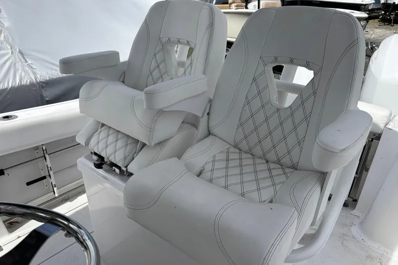 Slide: The Image of 2021 Sportsman Open 252 Center Console boat seats with diamond stitching and armrests. - 11