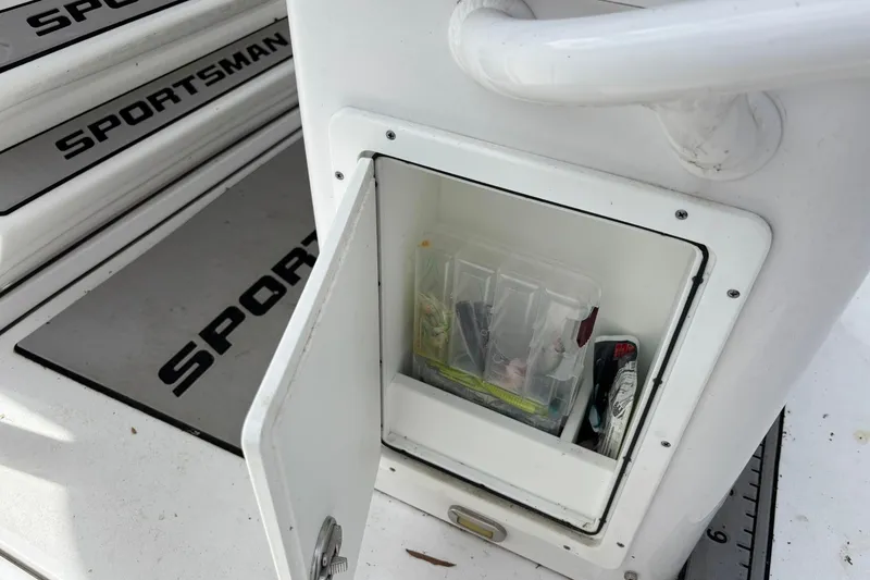 Slide: The Image of Open storage compartment on 2021 Sportsman Open 252 Center Console boat. - 12