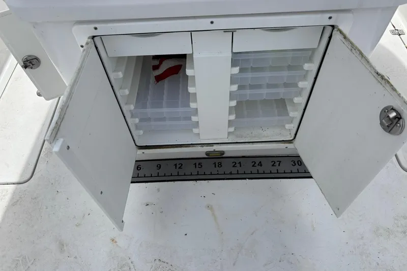 Slide: The Image of Open storage compartment on 2021 Sportsman Open 252 Center Console boat. - 13