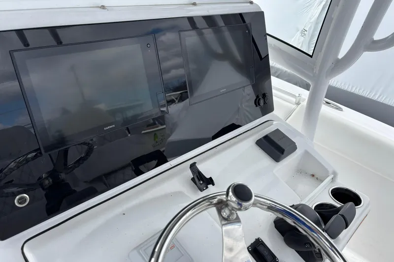 Slide: The Image of 2021 Sportsman Open 252 Center Console dashboard with dual Garmin displays and steering wheel. - 16
