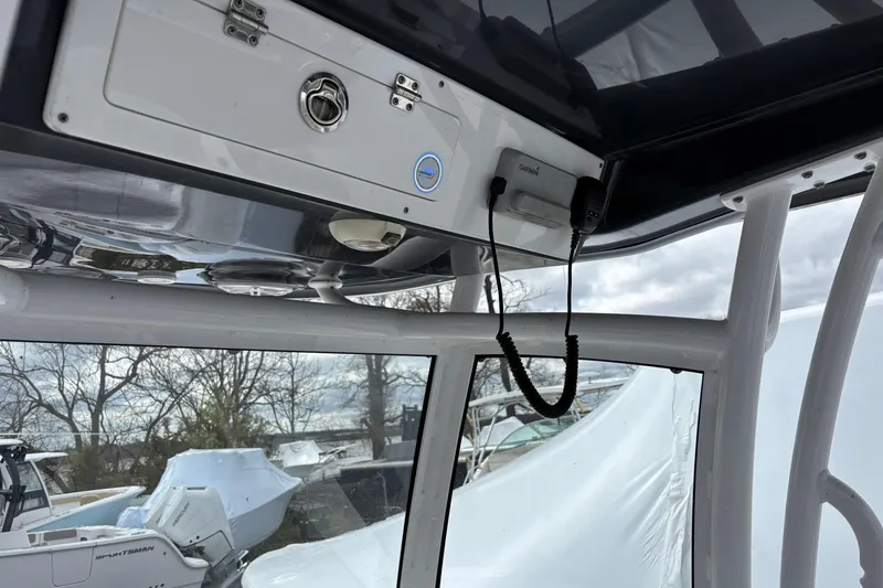 Slide: The Image of 2021 Sportsman Open 252 Center Console boat interior with electronics and storage compartment. - 17