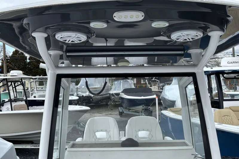 Slide: The Image of 2021 Sportsman Open 252 Center Console boat interior with speakers and seating. - 21