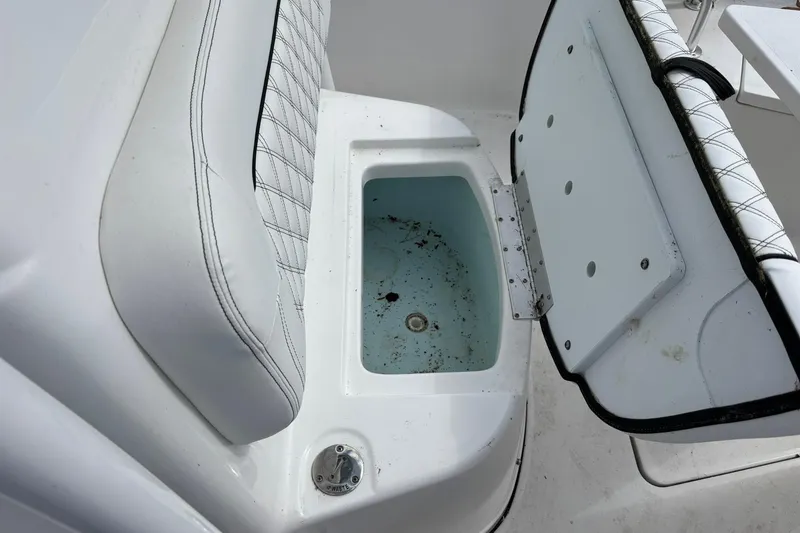 Slide: The Image of Open storage compartment on a 2021 Sportsman Open 252 Center Console boat. - 23