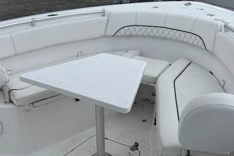Slide: The Image of 2021 Sportsman Open 252 Center Console boat with white seating and table. - 24