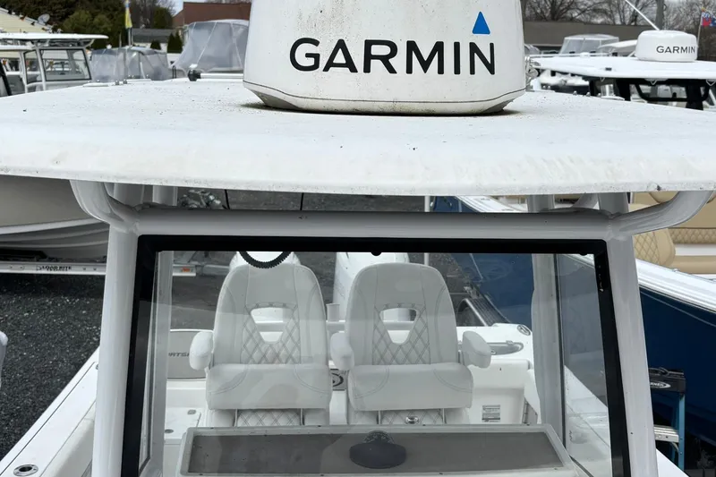 Slide: The Image of 2021 Sportsman Open 252 Center Console with Garmin equipment, featuring dual white seats. - 26