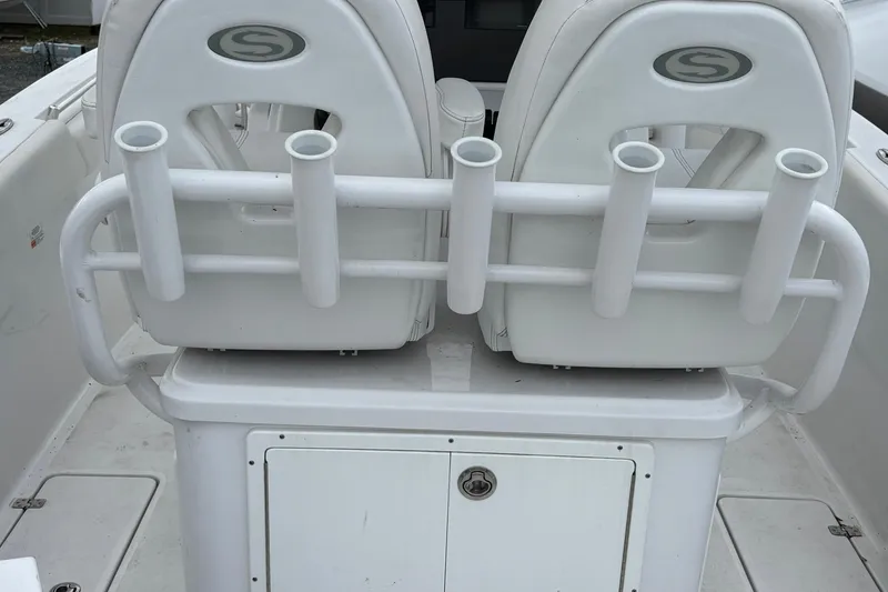 Slide: The Image of 2021 Sportsman Open 252 Center Console boat seating with rod holders. - 7