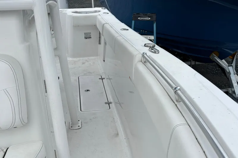 Slide: The Image of 2021 Sportsman Open 252 Center Console boat interior with white seating and storage compartments. - 8