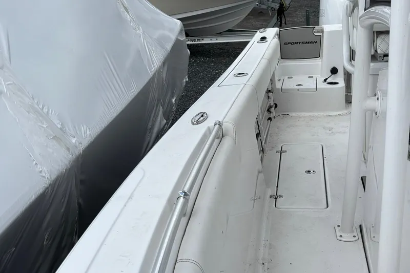 Slide: The Image of 2021 Sportsman Open 252 Center Console boat interior, featuring clean white deck and seating. - 9