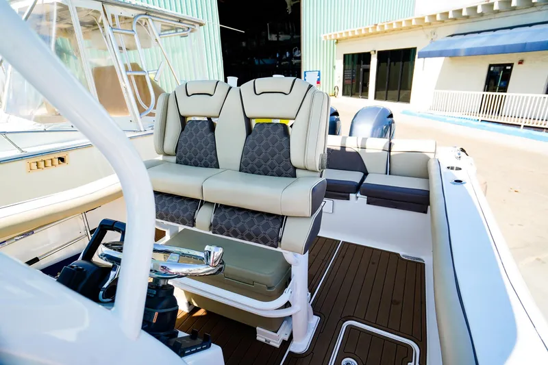 Slide: The Image of 2021 Tidewater 256 LXF boat interior with plush seating and modern helm. - 8