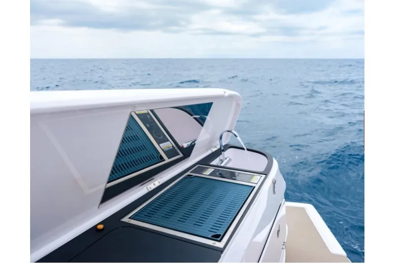 Slide: The Image of 2027 Axopar 45 Sun-Top yacht with sleek deck design on open sea. - 10