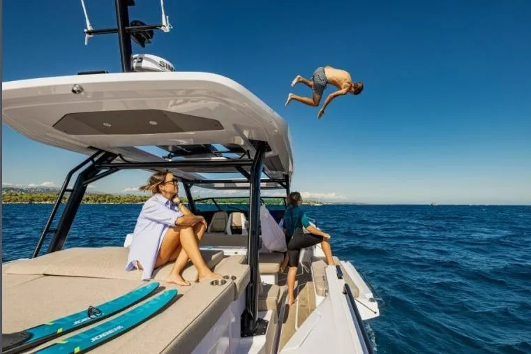 Slide: The Image of 2027 Axopar 45 Sun-Top boat with people enjoying a sunny day on the water. - 4
