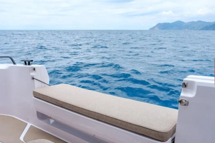 Slide: The Image of 2027 Axopar 45 Sun-Top boat with ocean view and distant mountains. - 9