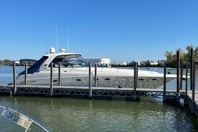 Slide: The Image of 2001 Sea Ray 460 Sundancer yacht docked on a sunny day. - 2