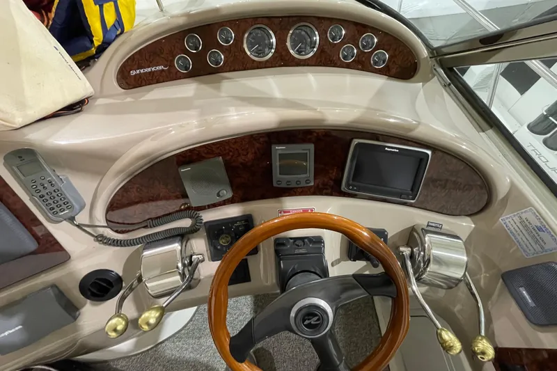 Slide: The Image of 2001 Sea Ray Sundancer 460 helm with wood accents and navigation instruments. - 20