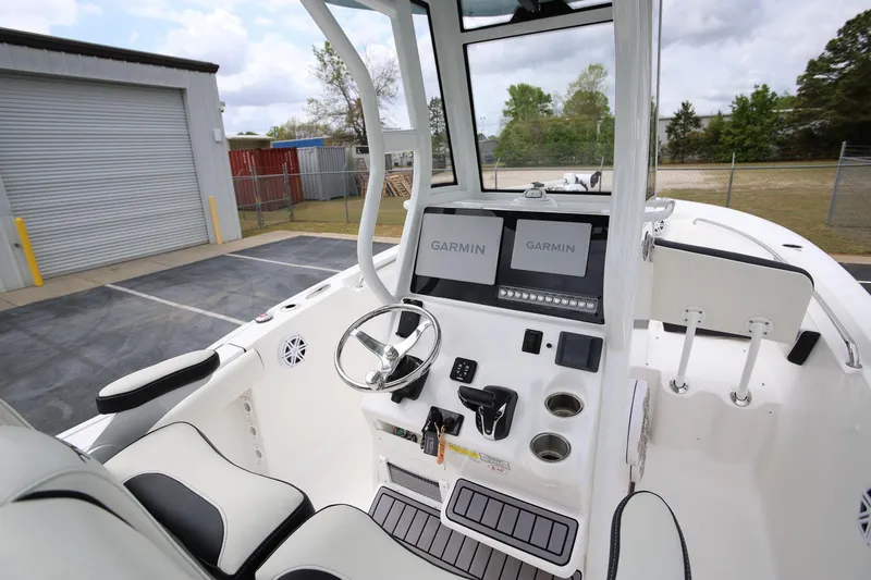 Slide: The Image of 2023 Tidewater 232 SS boat cockpit with Garmin displays and steering wheel. - 11