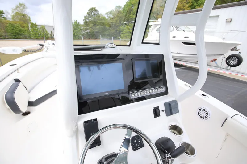 Slide: The Image of 2023 Tidewater 232 SS boat dashboard with modern navigation screens and controls. - 12