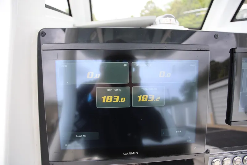 Slide: The Image of Garmin display on 2023 Tidewater 232 SS boat showing trip and total hours. - 13