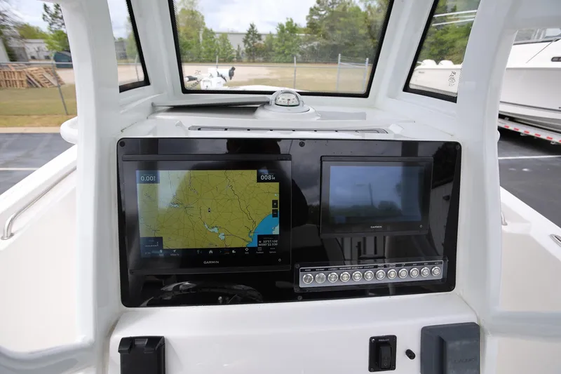 Slide: The Image of 2023 Tidewater 232 SS boat dashboard with Garmin navigation screens and controls. - 14