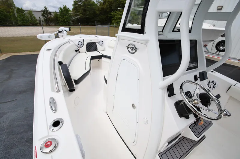 Slide: The Image of 2023 Tidewater 232 SS boat interior with steering wheel and seating area. - 15