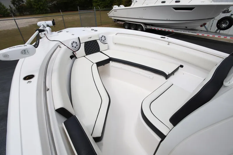 Slide: The Image of 2023 Tidewater 232 SS boat interior with white seating and modern design. - 17