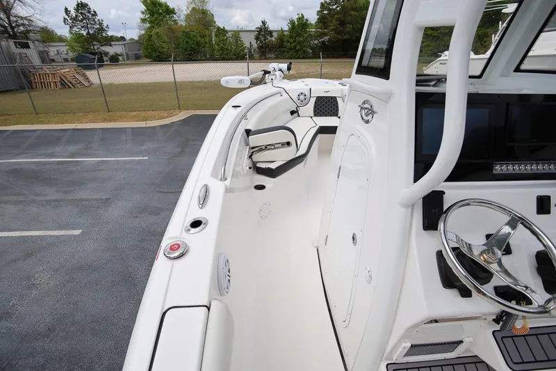 Slide: The Image of 2023 Tidewater 232 SS boat interior with steering wheel and seating area. - 19