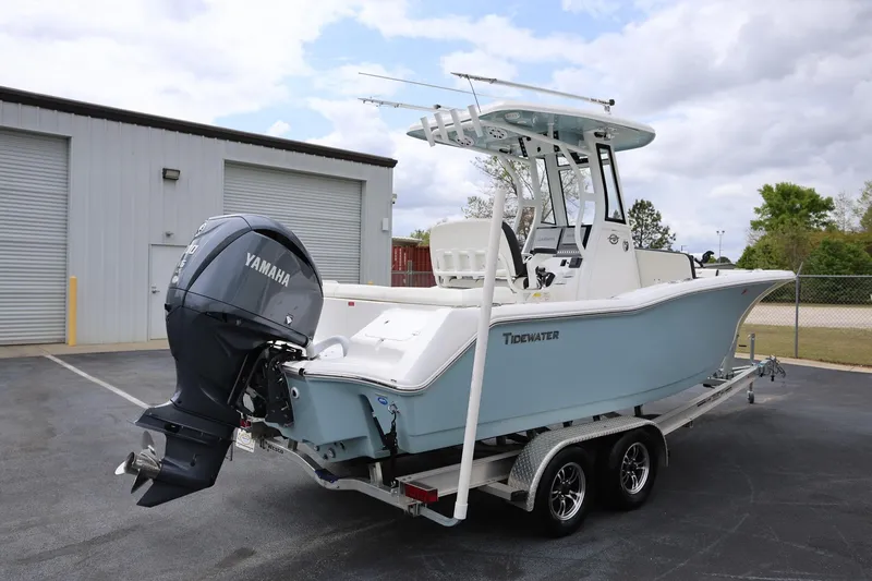 Slide: The Image of 2023 Tidewater 232 SS boat with Yamaha engine on trailer, parked outdoors. - 2