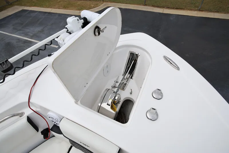 Slide: The Image of 2023 Tidewater 232 SS boat anchor compartment with open hatch and visible wiring. - 20