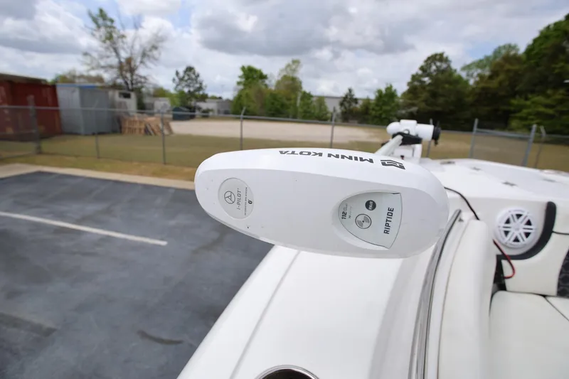 Slide: The Image of Minn Kota Riptide motor on 2023 Tidewater 232 SS boat, parked outdoors. - 21