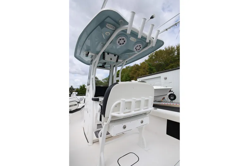 Slide: The Image of 2023 Tidewater 232 SS boat interior with T-top and rod holders. - 23