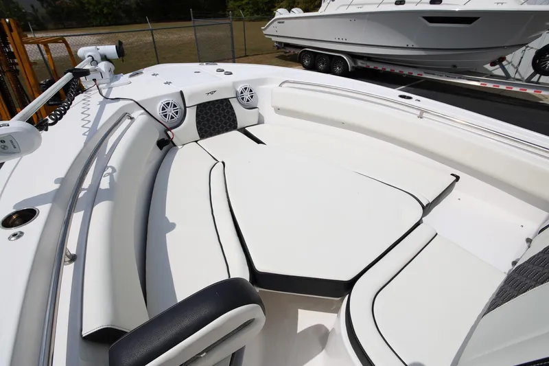 Slide: The Image of 2023 Tidewater 232 SS boat interior with white seating and speakers. - 24