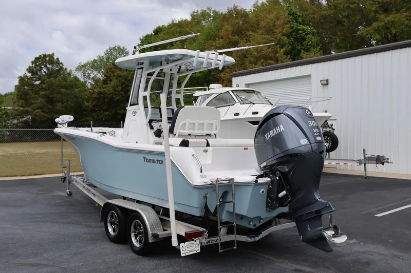 Slide: The Image of 2023 Tidewater 232 SS boat with Yamaha engine on trailer, parked outdoors. - 4