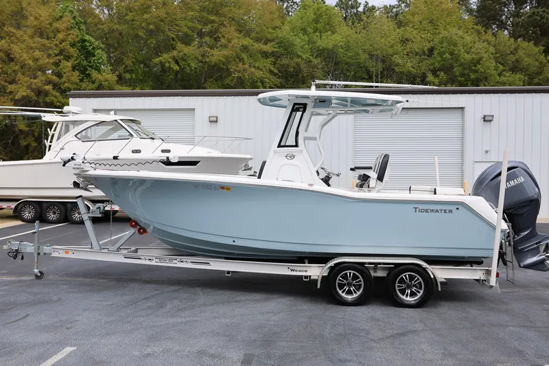 Slide: The Image of 2023 Tidewater 232 SS boat on trailer, parked outdoors near a building. - 5