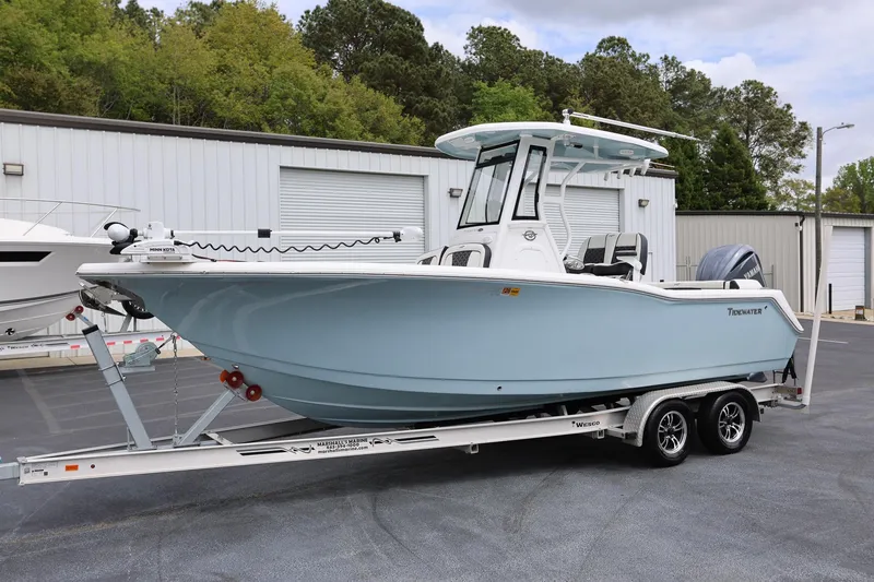 Slide: The Image of 2023 Tidewater 232 SS boat on trailer, parked outdoors near storage facility. - 6