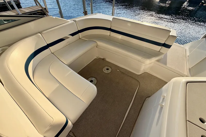 Slide: The Image of Luxurious seating area on a 2000 Formula 280 Bowrider boat, docked by the water. - 10