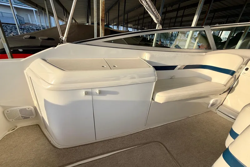 Slide: The Image of Interior of a 2000 Formula 280 Bowrider boat, featuring white seating and storage compartments. - 11