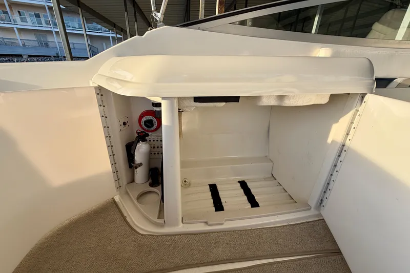 Slide: The Image of Interior storage compartment of a 2000 Formula 280 Bowrider boat with safety equipment. - 12