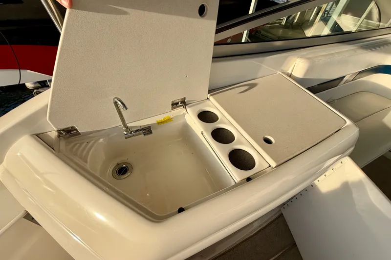 Slide: The Image of Sink and cup holders on a 2000 Formula 280 Bowrider boat. - 13