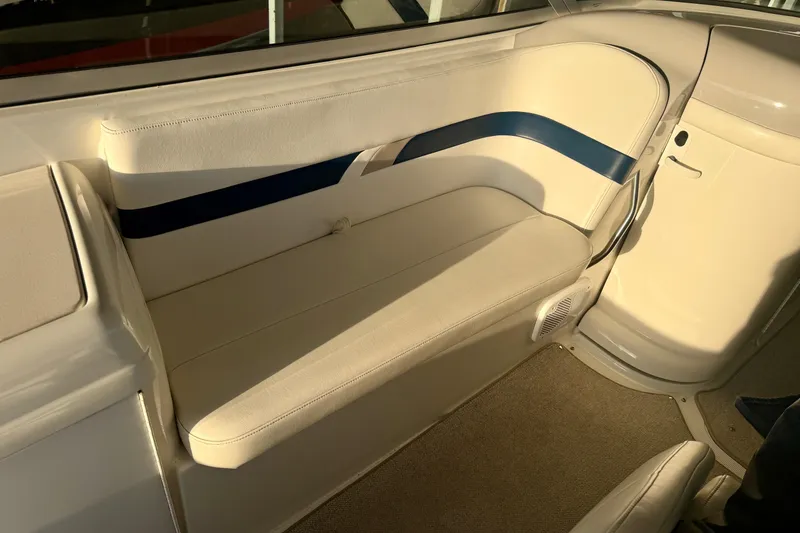Slide: The Image of Interior seating of a 2000 Formula 280 Bowrider boat, featuring white and blue upholstery. - 14