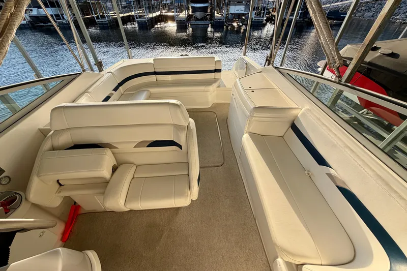 Slide: The Image of Interior of a 2000 Formula 280 Bowrider boat with white seating and waterfront view. - 16