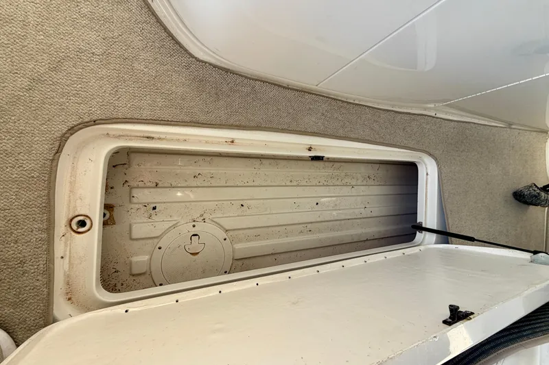 Slide: The Image of Open storage compartment on a 2000 Formula 280 Bowrider boat, showing interior details. - 17
