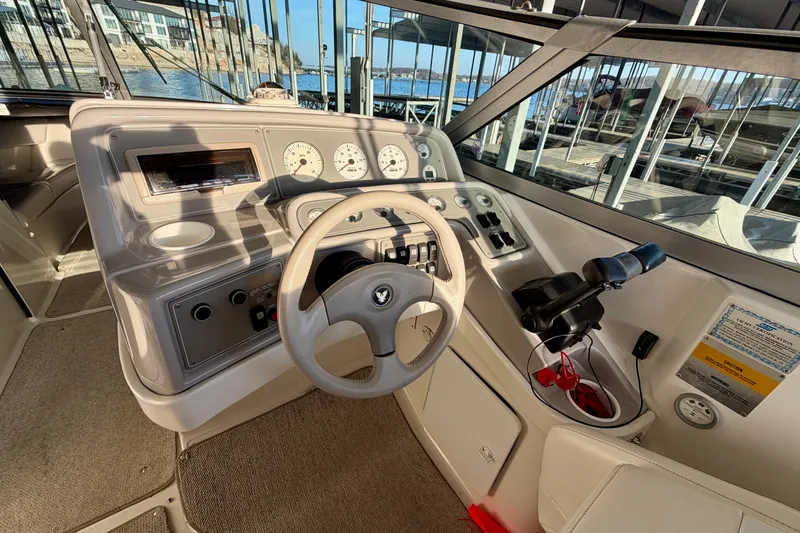 Slide: The Image of Steering console of a 2000 Formula 280 Bowrider boat, docked at a marina. - 18