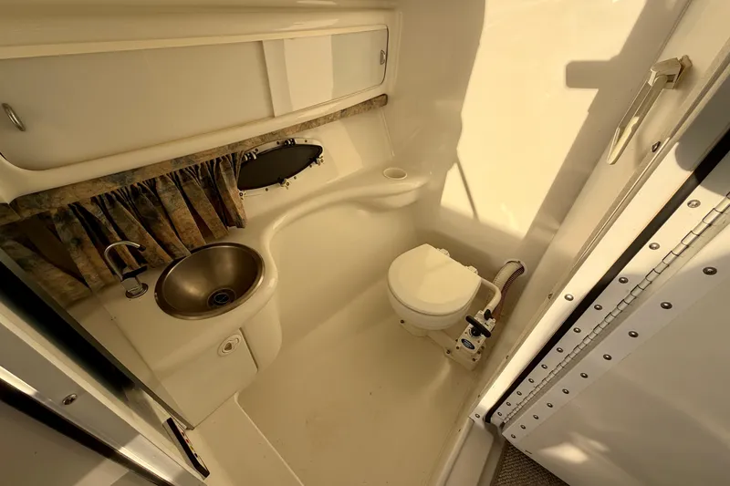 Slide: The Image of Interior of a 2000 Formula 280 Bowrider boat bathroom with sink and toilet. - 22