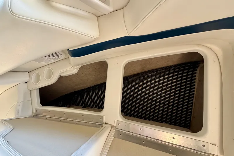 Slide: The Image of Interior storage compartments of a 2000 Formula 280 Bowrider boat with white seating. - 27