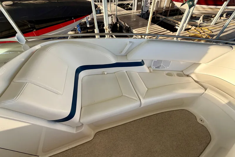 Slide: The Image of Interior seating of a 2000 Formula 280 Bowrider boat, featuring white upholstery and cup holders. - 28