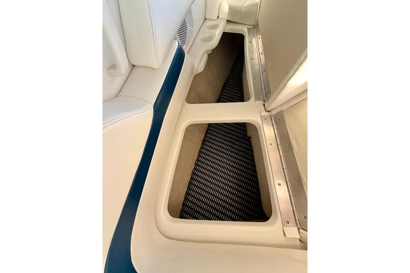 Slide: The Image of Storage compartment in a 2000 Formula 280 Bowrider boat, featuring white and blue interior. - 29