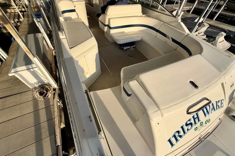 Slide: The Image of 2000 Formula 280 Bowrider boat with spacious seating, docked at a marina. - 8