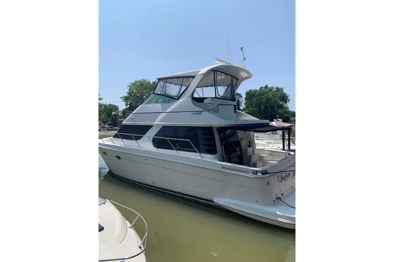 Slide: The Image of 2004 Carver 460 Voyager yacht docked in sunny marina. - 1