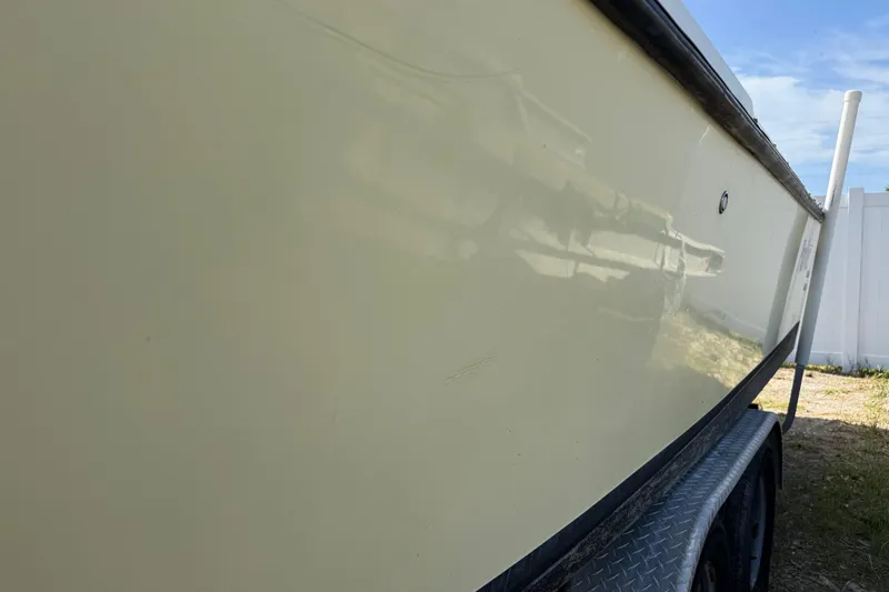 Slide: The Image of Side view of a 2001 Parker 2510 Walkaround boat on a trailer. - 10