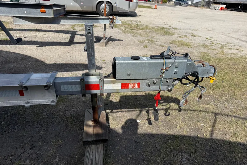 Slide: The Image of Trailer hitch for 2001 Parker 2510 Walkaround boat, parked on gravel. - 13